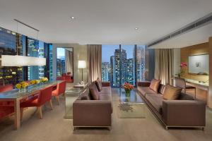 a living room with a couch and a table in a building at Crown Promenade Melbourne in Melbourne