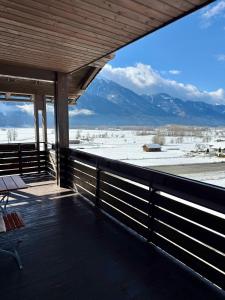 a porch with a view of the snow covered mountains at Ferienwohnungen Pernull in Waidegg