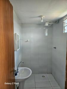 a white bathroom with a sink and a shower at Pousada Tereza in Piranhas +18 photos