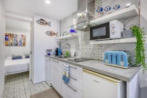 a small kitchen with a sink and a microwave at Studio in Historic Birgu in Birgu