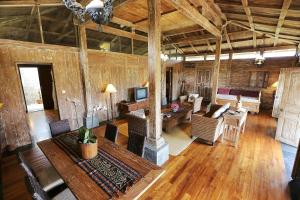 a living room with a couch and a fireplace at The Sanyas Retreat in Tabanan