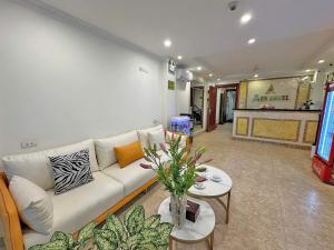 a living room with a white couch and a table at A25 Hotel - 109 Trúc Bạch in Hanoi