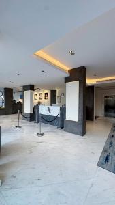 a large room with a white ceiling and a marble floor at Triple A Hotel in Riyadh