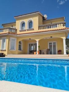 a house with a swimming pool in front of it at Villa Rosana in Rab +13 photos
