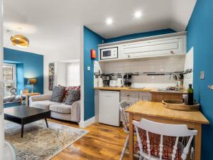 a kitchen and living room with blue walls at Errismore House in Clifden