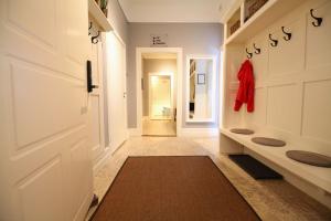 a hallway with a white door and a red jacket at Stationshuset bed and breakfast i Ed in Ed +24 photos