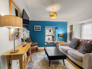 a living room with blue walls and a couch at Errismore House in Clifden