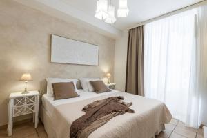 a bedroom with a large bed and a large window at Guest House Flores in Dubrovnik