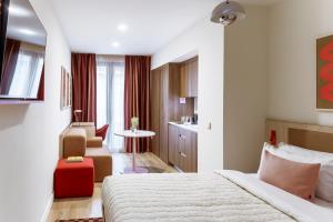 a hotel room with a bed and a chair at Numa Madrid Fuencarral in Madrid