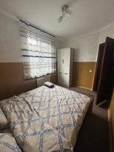 a bedroom with a bed with a book on it at Бордуляка 11 in Ternopil