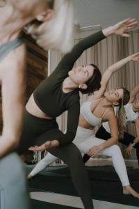 a group of women doing yoga in a mirror at Sun Lodge Schladming by Schladming-Appartements in Schladming