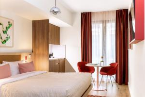 a hotel room with a bed and a table at Numa Madrid Fuencarral in Madrid