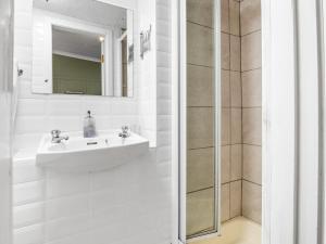 a white bathroom with a sink and a shower at Errismore House in Clifden +83 photos