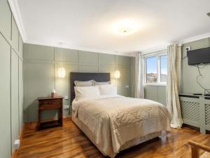 a bedroom with a large bed and a window at Errismore House in Clifden