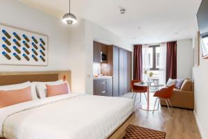 a hotel room with a bed and a desk at Numa Madrid Fuencarral in Madrid +25 photos