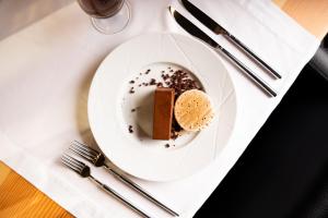 a white plate with a piece of cake on a table at Foz Côa Story House in Vila Nova de Foz Coa