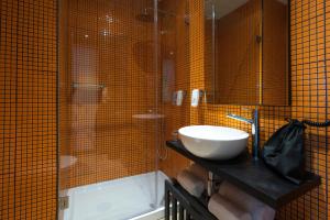 a bathroom with a sink and a shower at HF Ala Sul in Porto