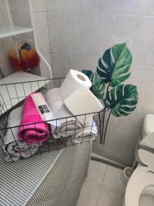 a wire basket with toiletries and towels on it in a bathroom at Dimi Guest House in Perea +22 photos