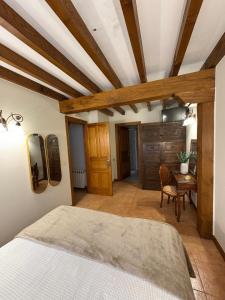 a bedroom with a bed and a table in a room at Eco de las Cuevas in Santillana del Mar