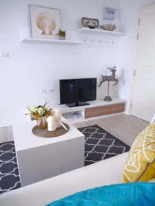 a living room with a couch and a tv at 4 Bedroom Luxury Suite at Baan Kieng Fah in Hua Hin