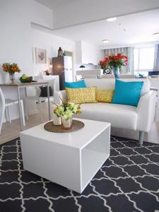 a living room with a white couch and a table at 4 Bedroom Luxury Suite at Baan Kieng Fah in Hua Hin