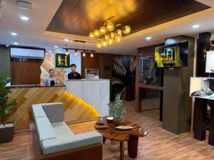 a lobby of a restaurant with a reception counter at Hollywood Hotel Puerto Princesa in Puerto Princesa City