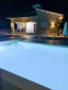 a swimming pool in front of a house at night at Villa D'Angelo in Casalbordino