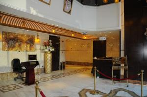 a lobby with a desk and a stage in a building at حديقة الروز in Al Masfalah