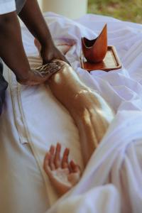 a woman laying on a bed with a shoe on it at Matemwe Attitude - Adults Only in Matemwe