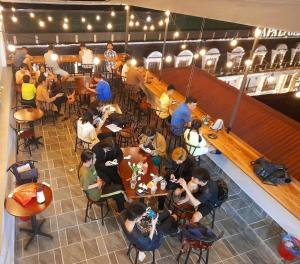 a group of people sitting at tables in a restaurant at OnMe in Sapa
