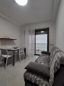a living room with a couch and a dining table at Yellow Dream B&B in Torre Melissa