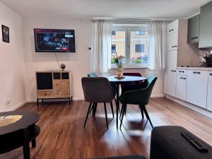 a kitchen and dining room with a table and chairs at Apartment Ramazotti - inklusive Eintritt in die Alpentherme in Bad Hofgastein