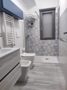 a bathroom with a toilet and a shower at Yellow Dream B&B in Torre Melissa +26 photos