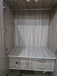 a wooden cabinet in a room with a wooden wall at Firangi Chacha in Bāra Banki