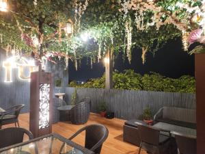a patio with tables and chairs at night at Firangi Chacha in Bāra Banki