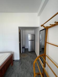 a kitchen with a refrigerator in a room at Saman Beach Guest House in Galle