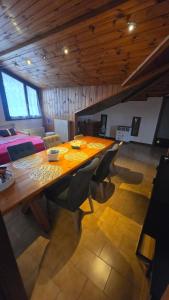 a dining room with a wooden table and chairs at Oleggio Home in Oleggio