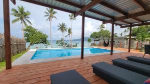 a swimming pool with a view of the ocean at Turtle Cove Resort in Siviri