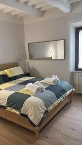 a bedroom with a large bed with towels on it at La terrazza del Papa in Pienza