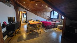 a living room with a table and a room with a couch at Oleggio Home in Oleggio