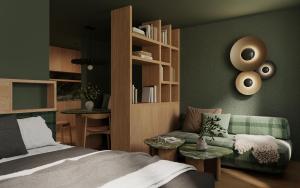 a bedroom with a bed and a green wall at Post Residence - Home of Memories - Dolomites in San Candido