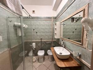 a bathroom with a toilet and a sink and a shower at Hotel Al Faro in Licata +75 photos