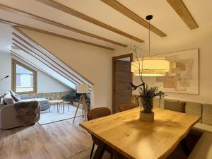 a living room with a table and a couch at Atico de lujo en el Pirineo in El Pueyo de Jaca