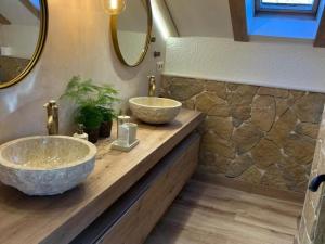 a bathroom with two sinks on a wooden counter at Atico de lujo en el Pirineo in El Pueyo de Jaca +22 photos