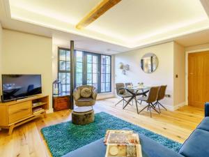 a living room with a couch and a tv and a table at 2 Bed in Keighley oc-83162 in Cononley