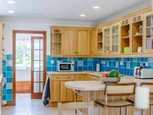 a kitchen with wooden cabinets and a table at 4 Bed in Southampton oc-82920 in Netley