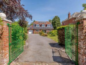 an entrance to a brick house with a green gate at 4 Bed in Southampton oc-82920 in Netley