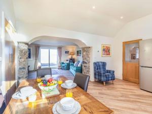a dining room and living room with a table and chairs at 2 Bed in Mindrum oc-86637 in Carham