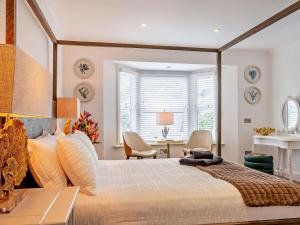 a bedroom with a large bed and a desk at 3 Bed in Shanklin oc-92053 in Shanklin