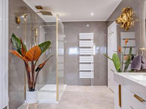 a bathroom with a shower with a plant in a vase at 3 Bed in Shanklin oc-92053 in Shanklin +40 photos
